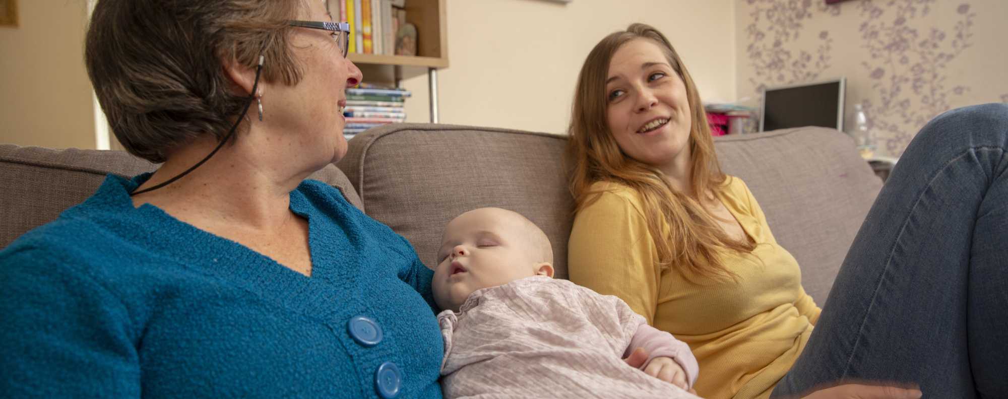 volunteer mum and dad pushing triplets